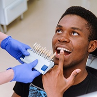 a patient showing his teeth to a dentist