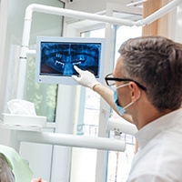 dentist showing a patient their dental X-rays 