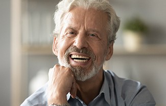 man smiling after getting dentures