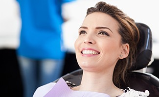 Woman smiles at checkup with Reno dentist