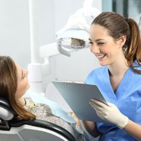 woman talking to dentist about cosmetic dentistry Reno