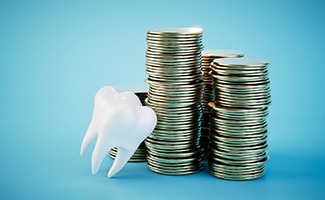 a tooth leaning on a stack of coins