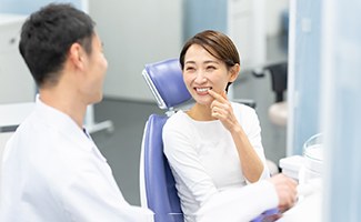 a patient talking to her dentist about dental crowns