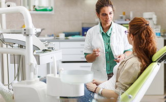 a dentist explaining the cost of dental crowns