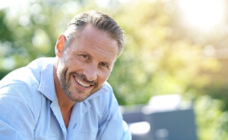 Man smiling after visiting a dentist in Reno