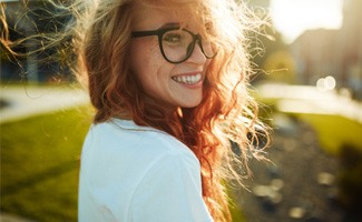 woman smiling after getting dental crowns in Reno