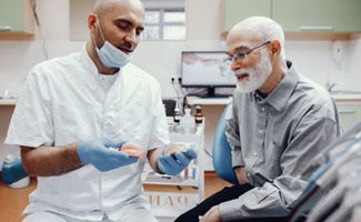 A dentist explaining how to keep a denture safe to his patient