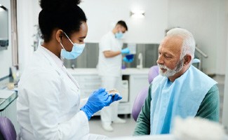 A patient talking to his dentist about his dentures