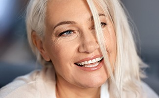 woman smiling with sun shining on face