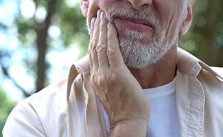 Older man with a toothache in Reno