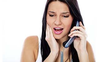 Woman calling an emergency dentist in Reno for guidance