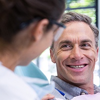 Implant dentist in Reno speaking to a smiling patient