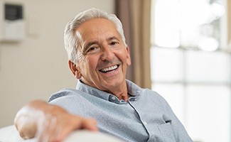 patient smiling after getting dental implants in Reno