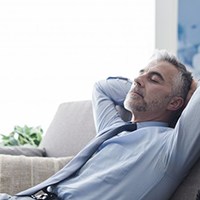 a man resting after undergoing dental implant surgery