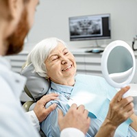 a patient smiling after receiving her dental restorations