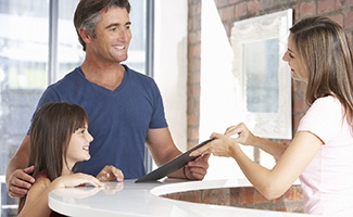 Patient and receptionist discussing how to pay for Invisalign in Reno