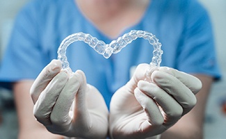 Dentist holding Invisalign in Reno in a heart shape