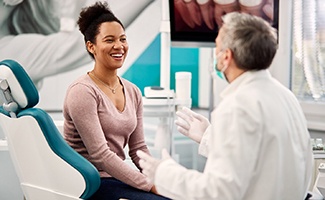 a smiling patient talking with a sedation dentist