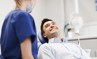 a patient smiling at his sedation dentist in Reno