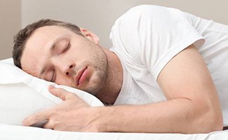 Man sleeping soundly in bed