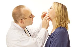 Dentist checking the fit of a sleep apnea appliance