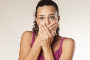 Woman covering her mouth