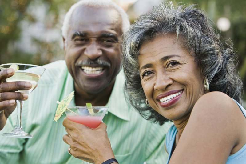 Happy senior couple enjoying drinks.