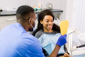 dentist showing patient their smile in a mirror