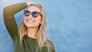 woman smiling with sunglasses