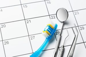 dental tools sitting on top of a calendar