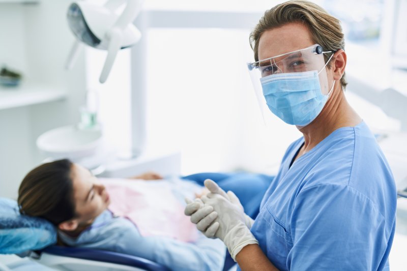 a male dentist in Reno wearing personal protective equipment before seeing a patient