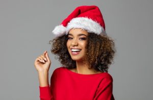 smiling woman wearing santa hat