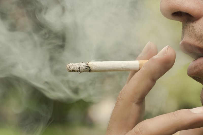 Close-up of a bearded man smoking a cigarette